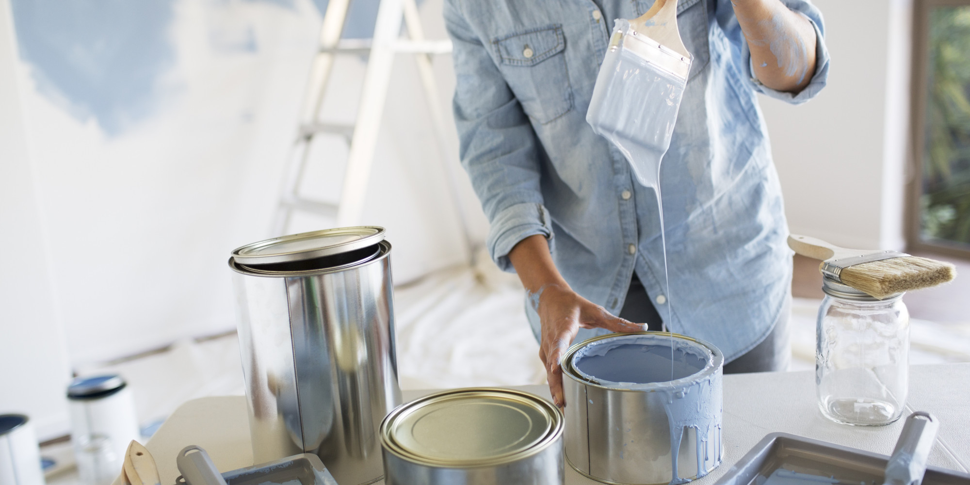Woman holding paintbrush with blue paint